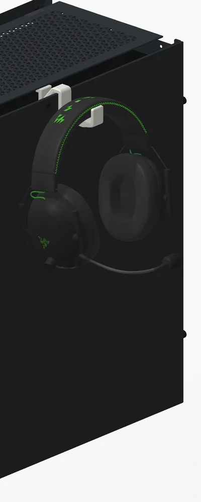 Headphones hanging on the off-white holder clipped to the top of a Corsair 5000D case