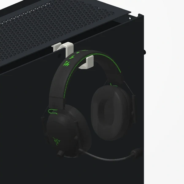 Headphones hanging on the off-white holder on the side of a Corsair 5000D