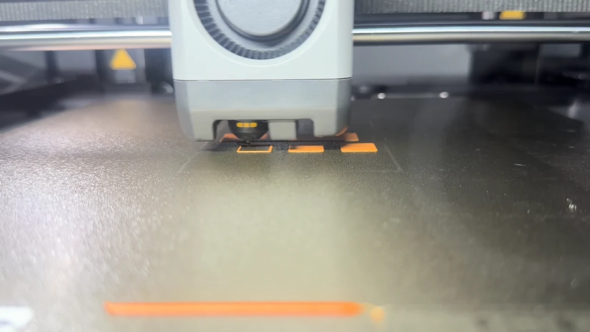 A frame from our workshop film showing a 3D printer at work